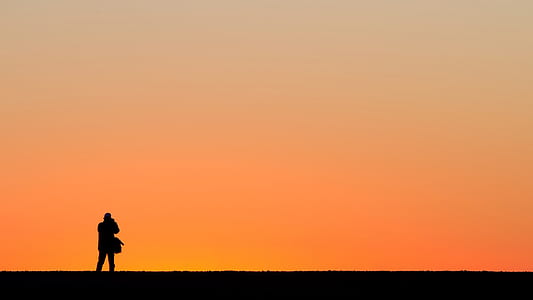 silhouette of man standing on mountain thumbnail