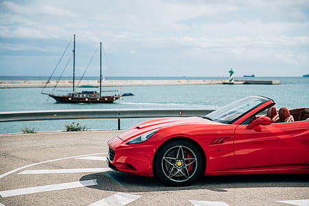 Red convertible sports car with alloy wheels thumbnail