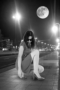 grayscale photography of woman wearing dress near street thumbnail