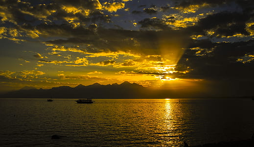silhouette photo of boat on body of water thumbnail