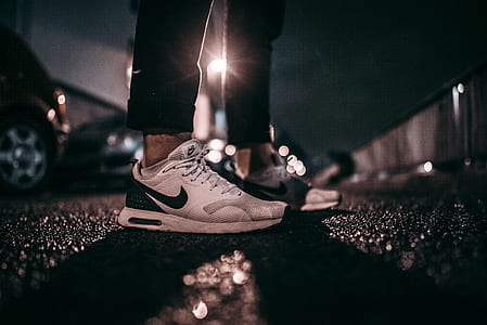 person standing near cars during nighttime thumbnail