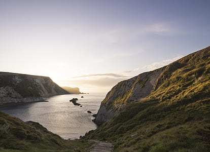 aerial photography of ocean and mountain during daytime thumbnail