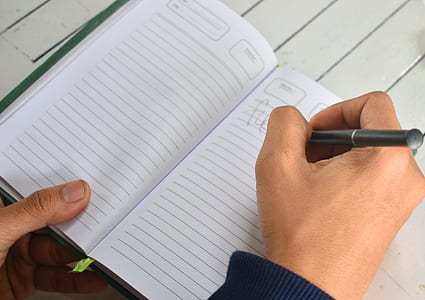 person holding black pen thumbnail