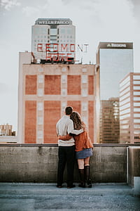 man standing beside woman on building roof at daytime thumbnail