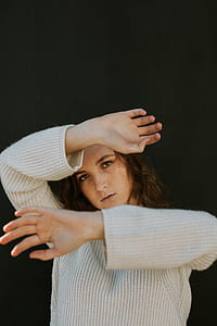woman standing covering her face thumbnail