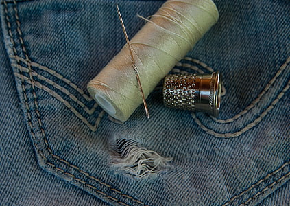gray needle on beige thread thumbnail