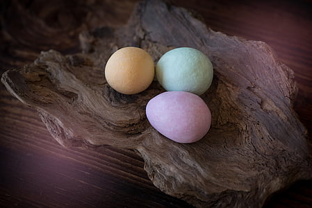 closeup photo of three egg bath bombs on wood bowl thumbnail