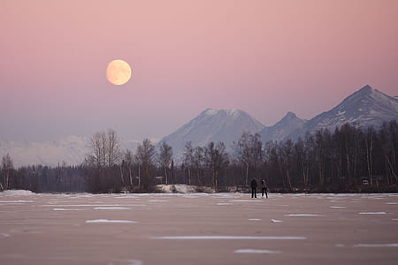 man standing on snow near mountain thumbnail