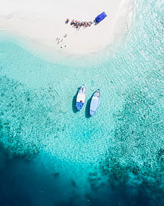 top view photo of two blue boat on body of water thumbnail