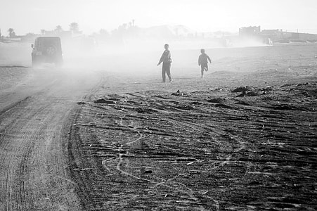 two children's standing on sand thumbnail