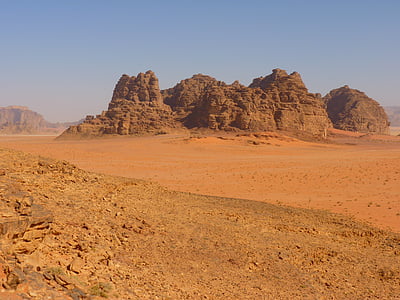 brown rock monolith under blue sky thumbnail