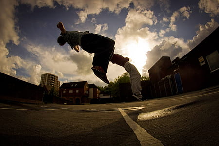 man on mid air beside building thumbnail