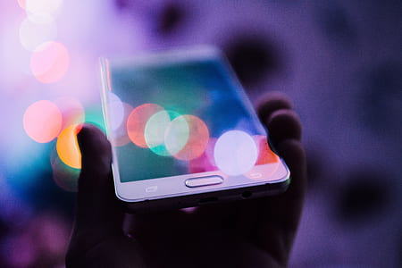 person holding white Samsung Galaxy smartphone thumbnail