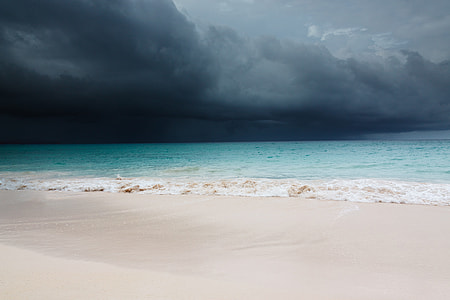 photo of black storm near seashore during daytime thumbnail
