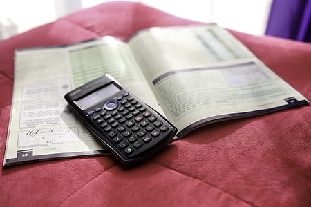 black scientific calculator on top of book thumbnail