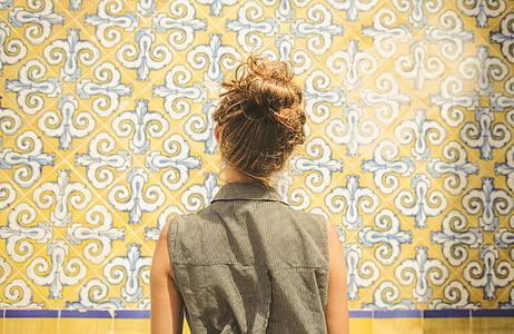 woman standing in front of floral wall painting thumbnail