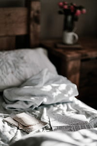 selective focus photo of opened book on top of bed thumbnail