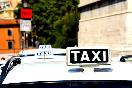 white taxi cabs during daytime thumbnail