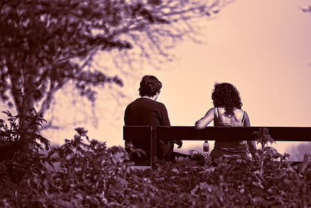 man and woman sitting on bench thumbnail