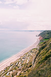 aerial photography of houses on cliff near sea at daytime thumbnail