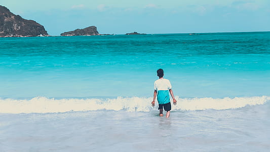 Photo of Man Walking by the Seashore thumbnail