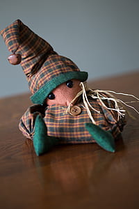 brown and green scarecrow plush toy on brown surface thumbnail