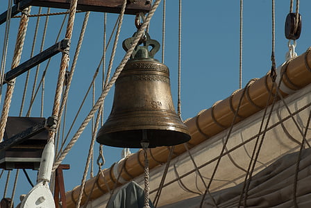 brass-colored bell hanged on brown rack thumbnail
