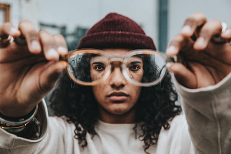 man holding eyeglasses with white frames thumbnail