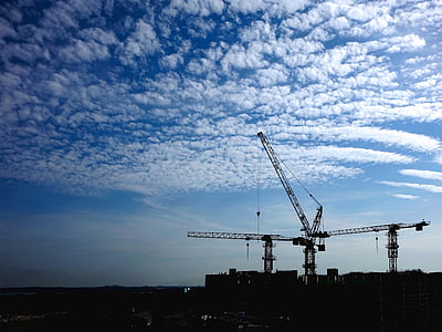 gray metal structure under white and blue cloudy sky during daytime thumbnail