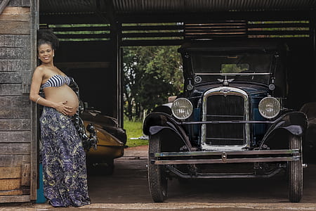 woman pregnant holding tummy on ground thumbnail