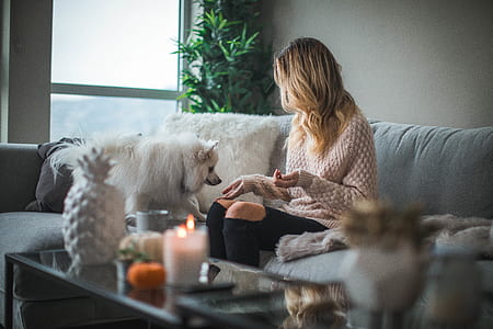 women's sitting on gray couch thumbnail