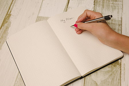 person holding silver and black pen thumbnail