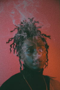 man in black with smoke thumbnail