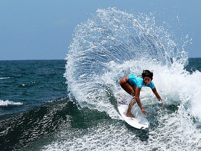 woman surfboarding during daytime thumbnail