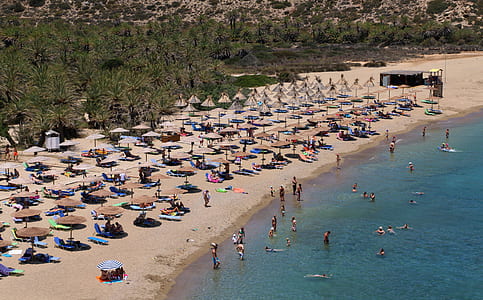aerial photography of people on white sand beach thumbnail