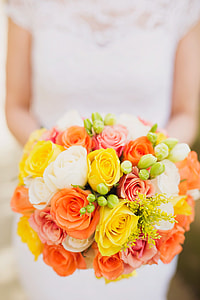 woman wearing white cap-sleeved dress holding yellow-orange-and-white rose bouquet thumbnail