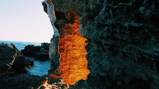 cave near sea at daytime thumbnail
