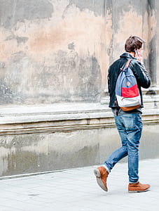 man in black jacket using smartphone thumbnail