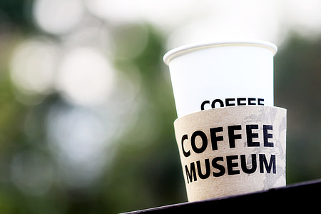 white coffee museum cup selective focus photography thumbnail