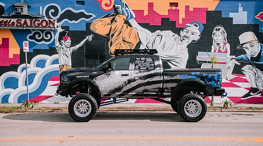 white and black monster truck on gray road thumbnail