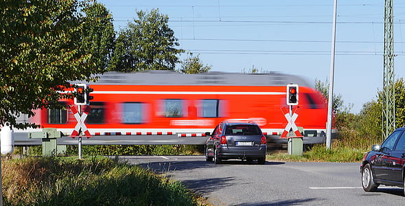 black SUV near passing train thumbnail