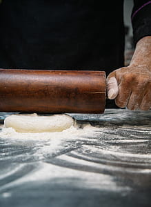 Person Using Brown Wooden Rolling Pin thumbnail