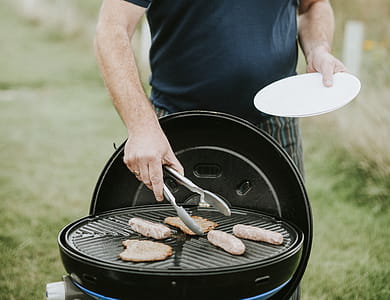 Man About to Pick Grilled Meat thumbnail