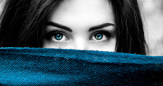 selective color photography of woman showing blue eyes and blue textile thumbnail