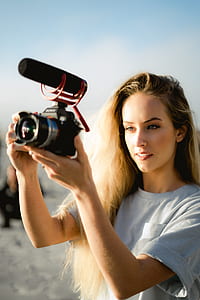 woman holding black bridge camera thumbnail