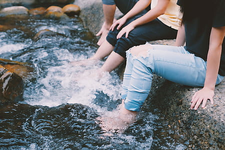 People In Jeans With Feet In Water thumbnail