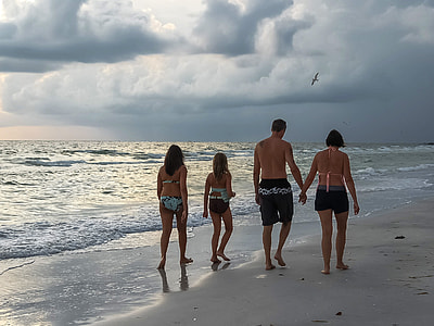 family walking on beach shore thumbnail