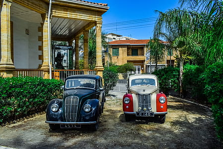 vintage blue and white and red cars parking outdoors thumbnail
