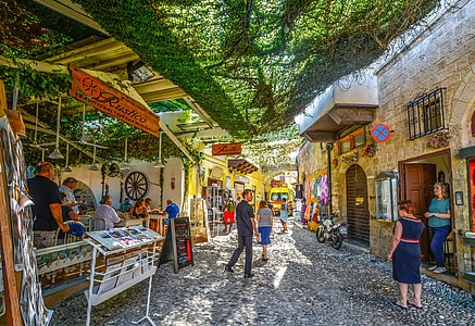 middle of the pathway photo of street stores and people thumbnail