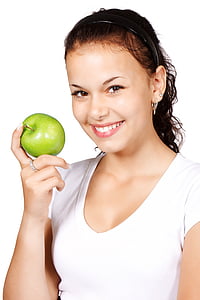 woman in white shirt holding green apple thumbnail
